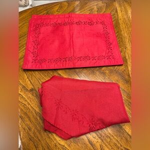 Red around 70” tablecloth with 4 matching placemats. New- great for Holidays.